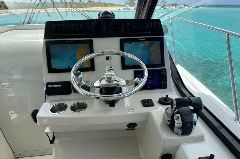  Yacht Photos Pics Cockpit of 2020 Boston Whaler 325 Conquest with navigation screens and steering wheel.
