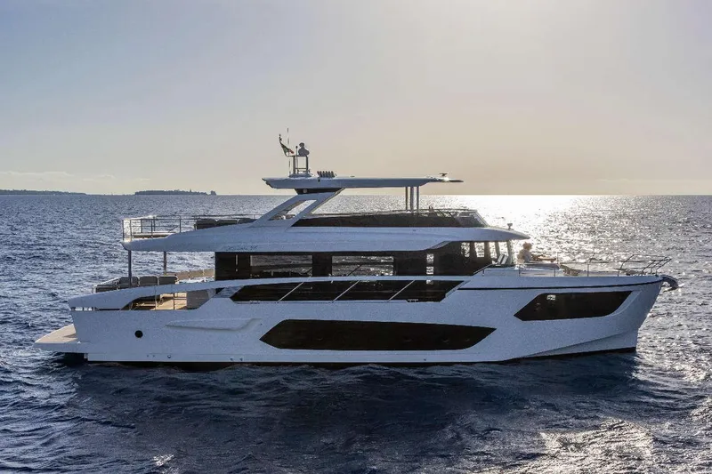  Yacht Photos Pics 2026 Absolute NAVETTA 75 yacht cruising on open sea at sunset.