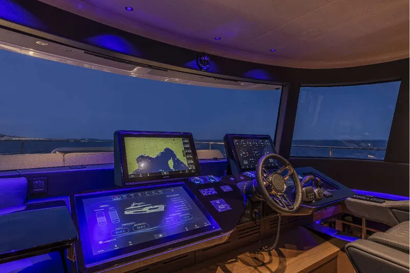  Yacht Photos Pics Luxurious 2026 Absolute NAVETTA 75 yacht cockpit with advanced navigation displays at night.