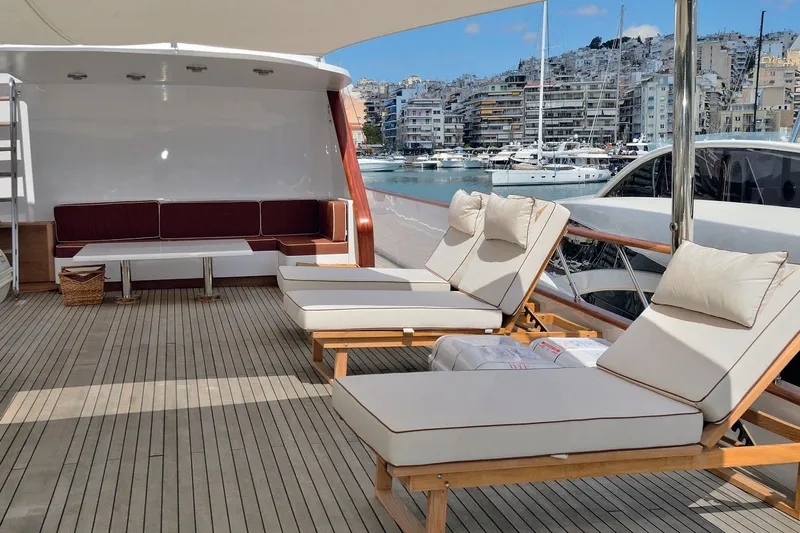 Madame Thelma Yacht Photos Pics Luxurious 1975 CRN Ancona Navetta 40 yacht deck with sun loungers and marina view.