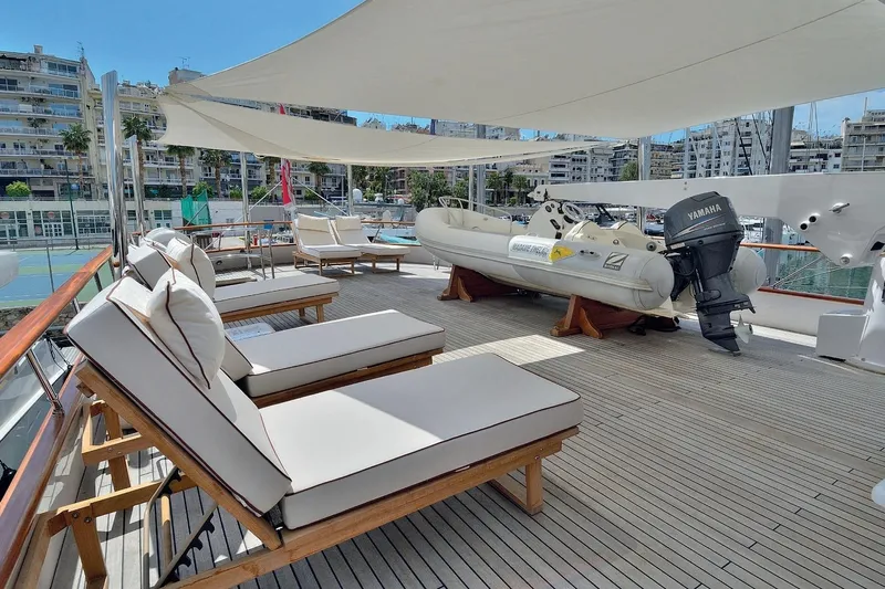 Madame Thelma Yacht Photos Pics Luxurious deck of 1975 CRN Ancona Navetta 40 yacht with sun loungers and inflatable boat.