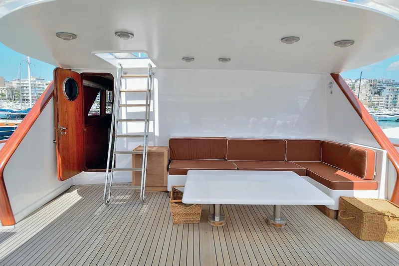 Madame Thelma Yacht Photos Pics Luxurious 1975 CRN Ancona Navetta 40 yacht deck with seating and table.