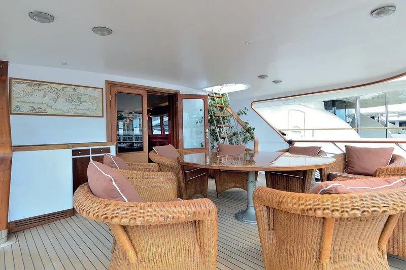 Madame Thelma Yacht Photos Pics Luxurious 1975 CRN Ancona Navetta 40 yacht deck with wicker seating and elegant decor.