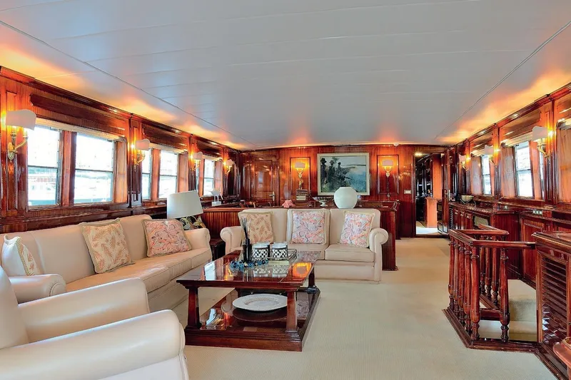 Madame Thelma Yacht Photos Pics Luxurious interior of 1975 CRN Ancona Navetta 40 yacht with elegant wood paneling and plush seating.