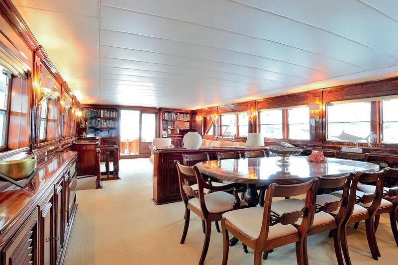 Madame Thelma Yacht Photos Pics Luxurious interior of 1975 CRN Ancona Navetta 40 yacht with elegant dining area and wooden furnishings.