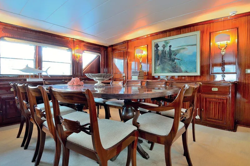 Madame Thelma Yacht Photos Pics Luxurious dining area on 1975 CRN Ancona Navetta 40 yacht with elegant wood paneling.