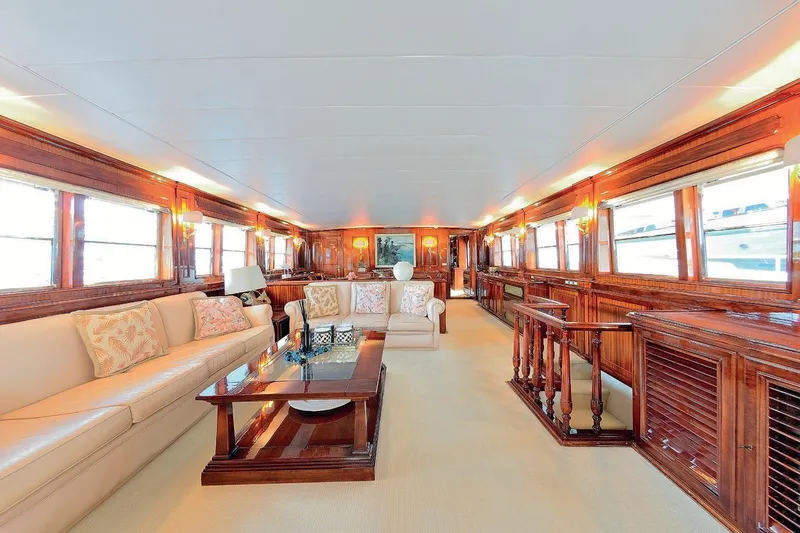 Madame Thelma Yacht Photos Pics Luxurious interior of 1975 CRN Ancona Navetta 40 yacht with elegant wood paneling and plush seating.