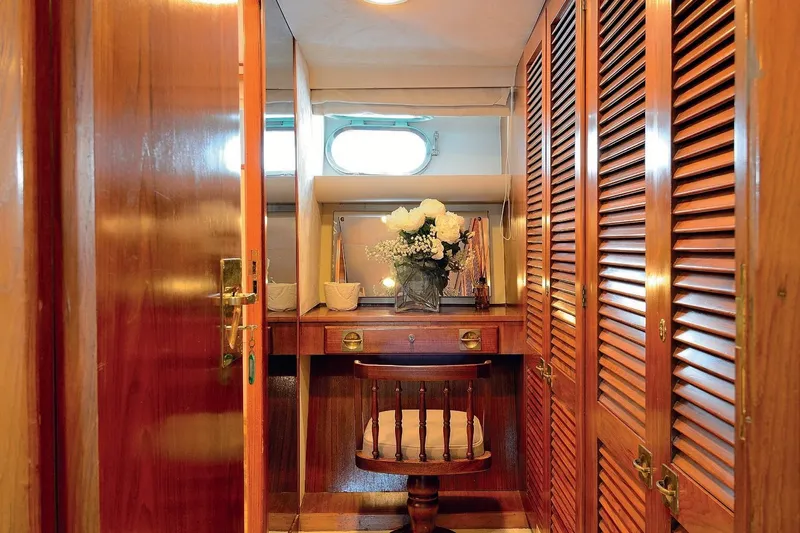 Madame Thelma Yacht Photos Pics Luxurious wooden interior of 1975 CRN Ancona Navetta 40 yacht with elegant vanity area.