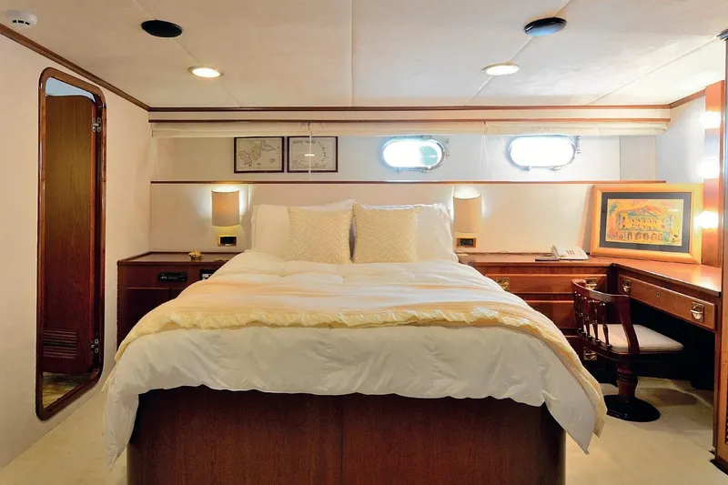 Madame Thelma Yacht Photos Pics Luxurious bedroom interior of 1975 CRN Ancona Navetta 40 yacht with elegant wood furnishings.