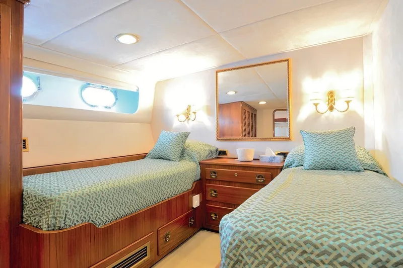 Madame Thelma Yacht Photos Pics Luxurious twin cabin interior on 1975 CRN Ancona Navetta 40 yacht, featuring elegant decor.