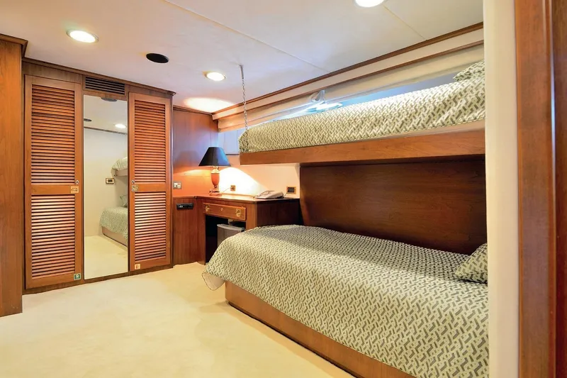 Madame Thelma Yacht Photos Pics Luxurious 1975 CRN Ancona Navetta 40 yacht cabin with wooden bunk beds and elegant decor.