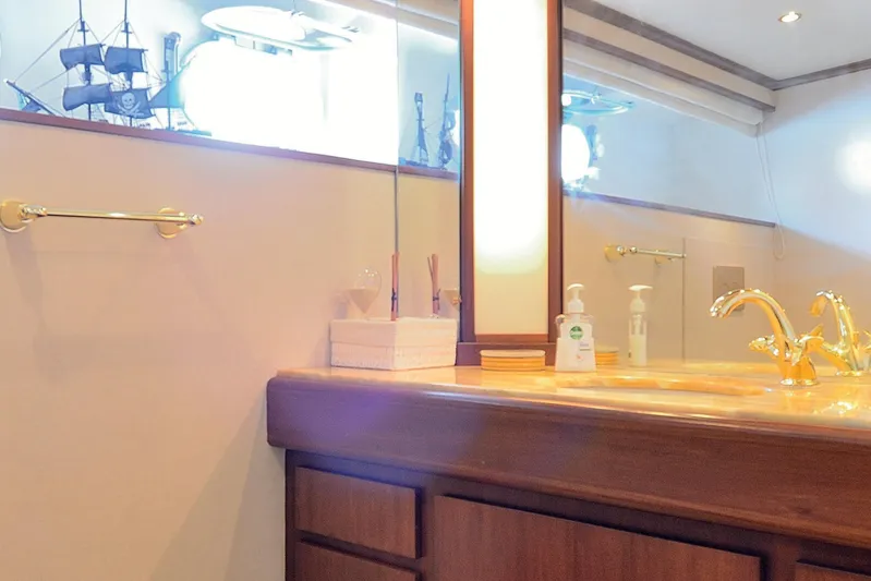 Madame Thelma Yacht Photos Pics Luxurious bathroom on 1975 CRN Ancona Navetta 40 yacht with elegant gold fixtures.