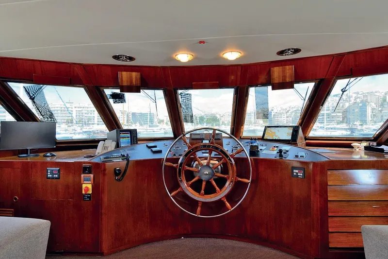 Madame Thelma Yacht Photos Pics Bridge of 1975 CRN Ancona Navetta 40 yacht with wooden steering wheel and navigation equipment.