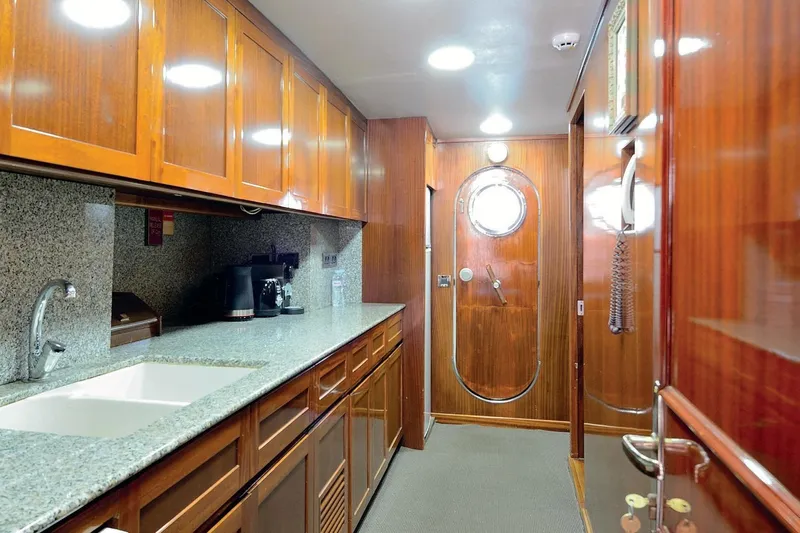 Madame Thelma Yacht Photos Pics Luxurious wooden interior of 1975 CRN Ancona Navetta 40 yacht kitchen.
