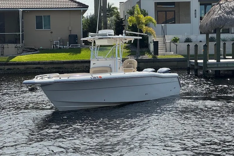  Yacht Photos Pics 2014 Stamas 317 Tarpon boat on water near residential dock.