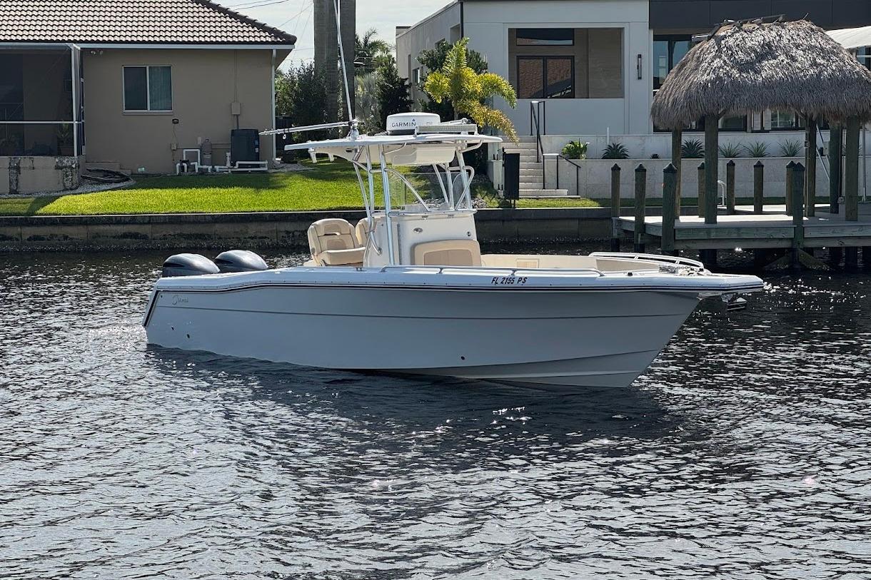 2014 Stamas 317 Tarpon boat on water near residential dock.