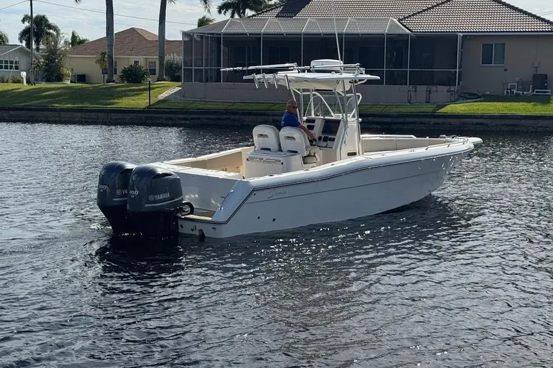  Yacht Photos Pics 2014 Stamas 317 Tarpon boat with dual Yamaha engines on a calm waterway.