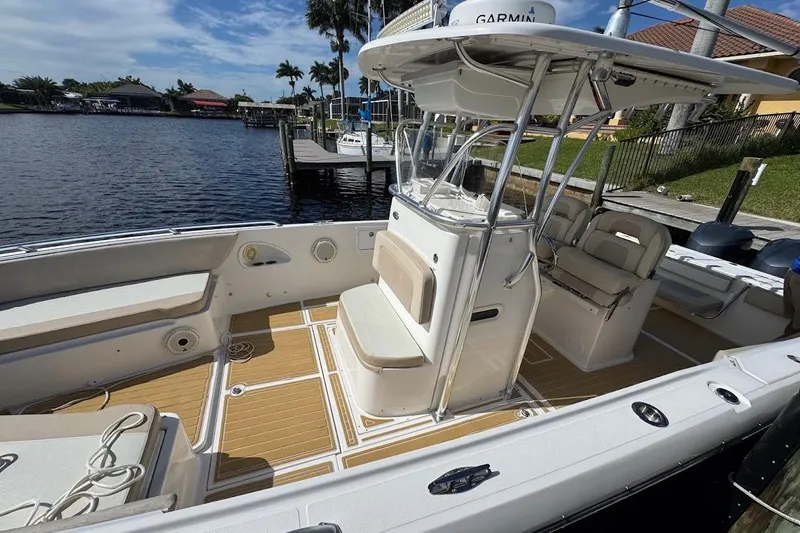  Yacht Photos Pics 2014 Stamas 317 Tarpon boat with spacious deck and seating, docked by waterfront.