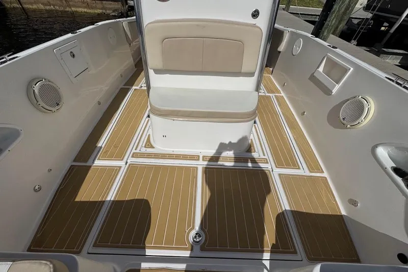  Yacht Photos Pics 2014 Stamas 317 Tarpon boat interior with tan cushioned seating and teak-style flooring.