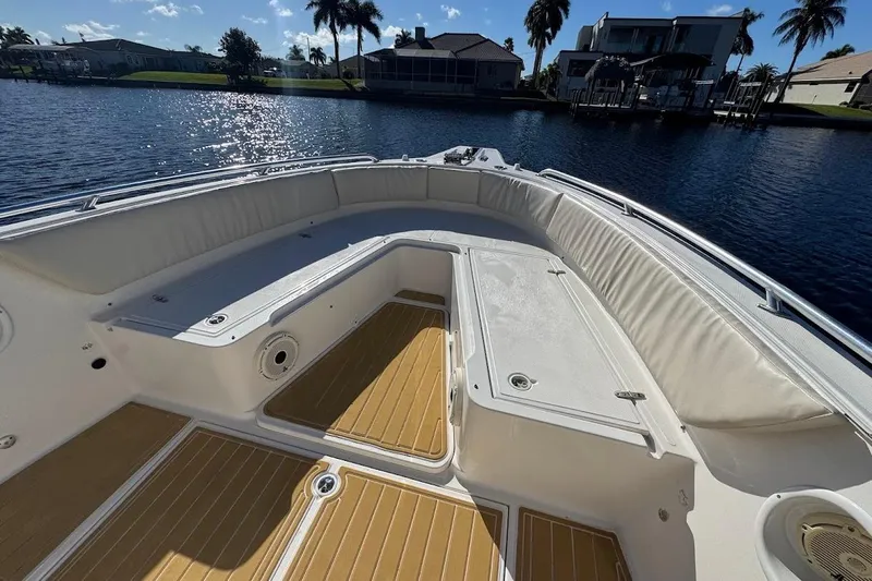  Yacht Photos Pics 2014 Stamas 317 Tarpon boat interior with cushioned seating and wooden flooring.