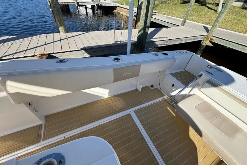  Yacht Photos Pics 2014 Stamas 317 Tarpon boat interior with seating and rod holders at dock.
