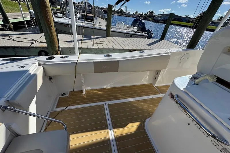  Yacht Photos Pics 2014 Stamas 317 Tarpon boat interior with wooden deck, docked by the water.
