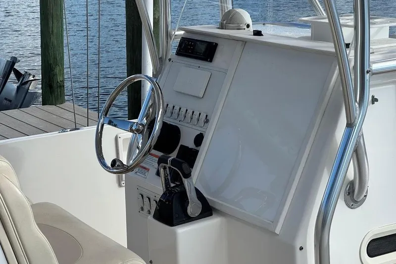  Yacht Photos Pics 2014 Stamas 317 Tarpon boat helm with steering wheel and control panel.
