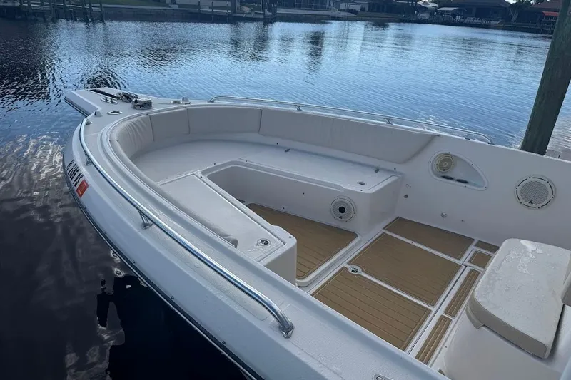  Yacht Photos Pics 2014 Stamas 317 Tarpon boat interior with seating and storage, docked by calm water.