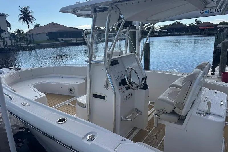  Yacht Photos Pics 2014 Stamas 317 Tarpon boat with helm, docked by waterfront homes.