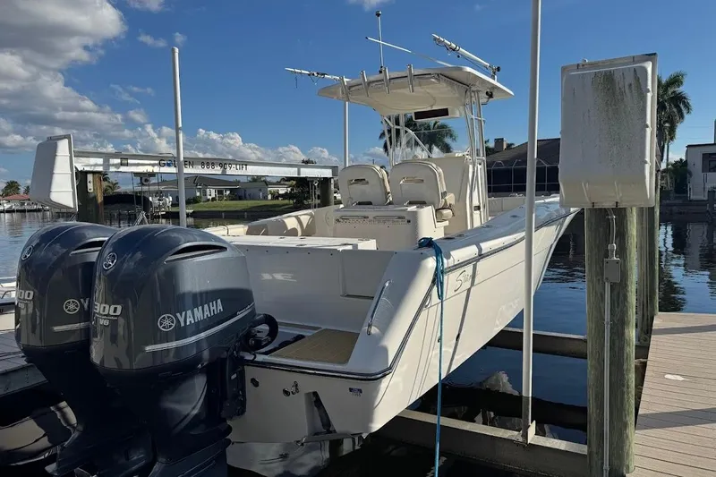  Yacht Photos Pics 2014 Stamas 317 Tarpon boat docked with twin Yamaha engines, under clear blue sky.
