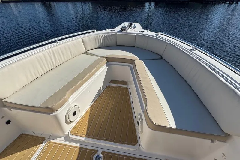  Yacht Photos Pics 2014 Stamas 317 Tarpon boat interior with cushioned seating and wooden deck.