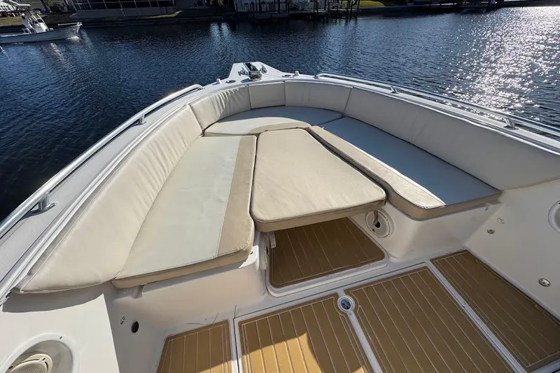  Yacht Photos Pics 2014 Stamas 317 Tarpon boat interior with cushioned seating and wooden flooring.