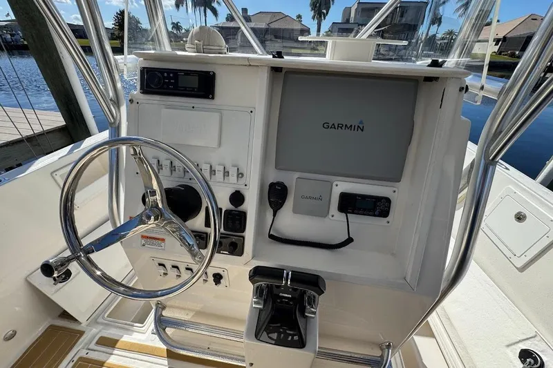  Yacht Photos Pics 2014 Stamas 317 Tarpon boat console with Garmin navigation system and steering wheel.