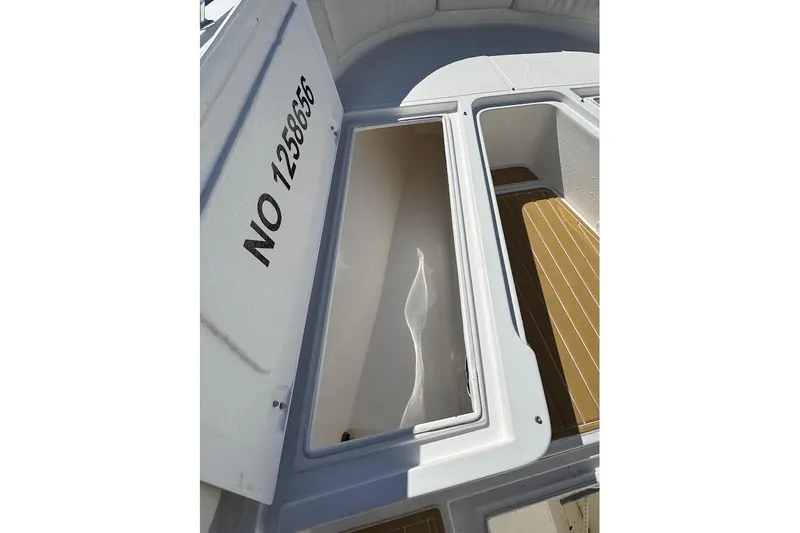  Yacht Photos Pics 2014 Stamas 317 Tarpon boat storage compartment with registration number visible.