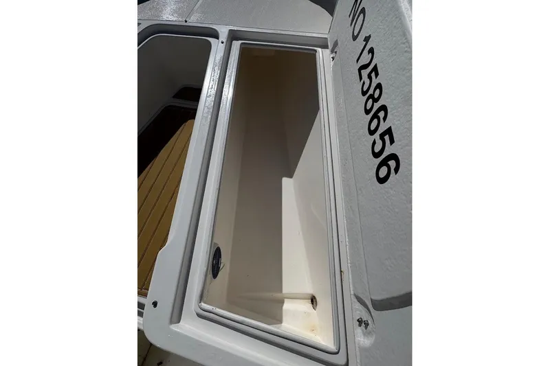  Yacht Photos Pics Open storage compartment on a 2014 Stamas 317 Tarpon boat, showing interior details.