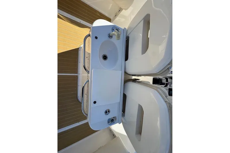  Yacht Photos Pics 2014 Stamas 317 Tarpon boat interior with sink and seating area.