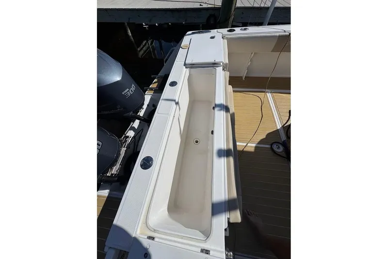  Yacht Photos Pics 2014 Stamas 317 Tarpon boat deck with open storage compartment and dual engines.