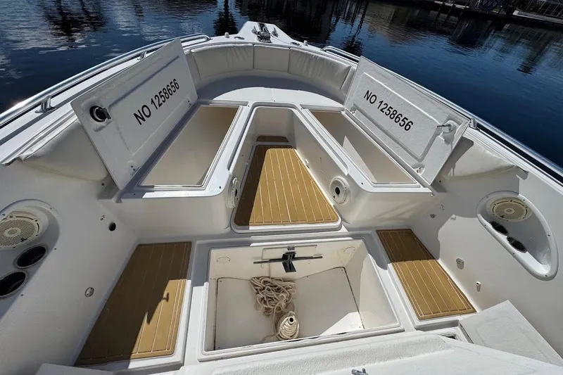  Yacht Photos Pics 2014 Stamas 317 Tarpon boat interior with open storage compartments and visible registration numbers.
