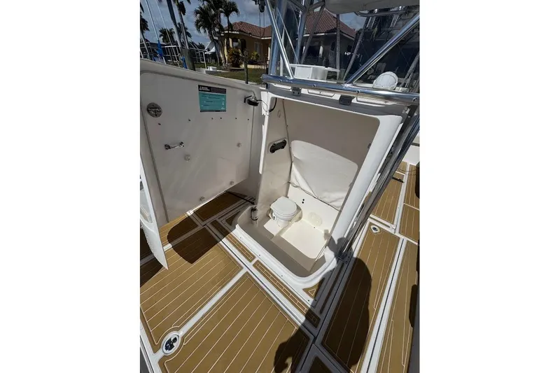  Yacht Photos Pics 2014 Stamas 317 Tarpon boat interior with open compartment and wooden deck flooring.