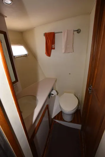 The Office Yacht Photos Pics 1987 Hatteras SportFish (w/CATS) bathroom with toilet, sink, and towel rack.