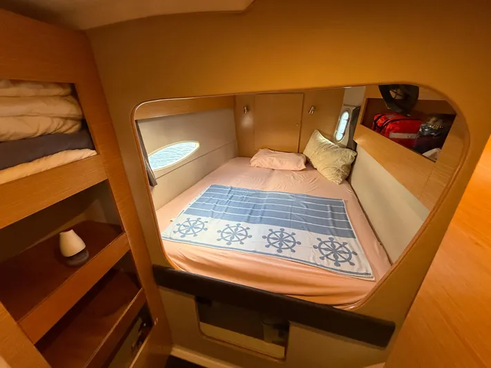 Benevah Yacht Photos Pics Cozy cabin interior of 2013 Fountaine Pajot Lipari 41 catamaran with bed and storage shelves.