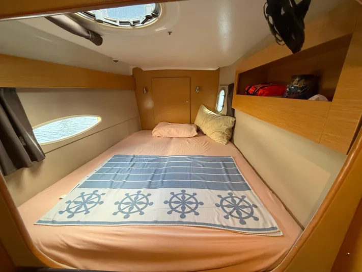Benevah Yacht Photos Pics Cozy cabin interior of 2013 Fountaine Pajot Lipari 41 catamaran with nautical-themed bedding.