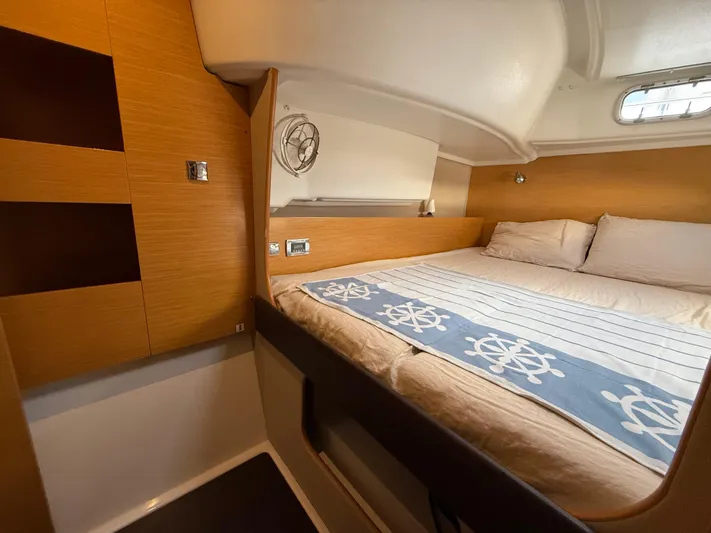 Benevah Yacht Photos Pics Cozy cabin interior of 2013 Fountaine Pajot Lipari 41 catamaran with nautical-themed bedding.