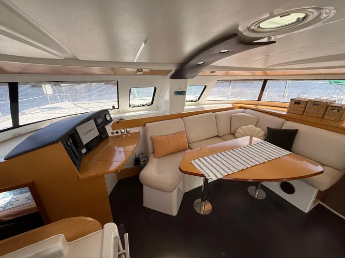 Benevah Yacht Photos Pics Interior of 2013 Fountaine Pajot Lipari 41 catamaran with cozy seating and navigation area.
