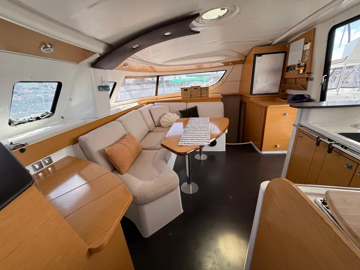 Benevah Yacht Photos Pics Interior of 2013 Fountaine Pajot Lipari 41 catamaran with modern seating and wooden finishes.