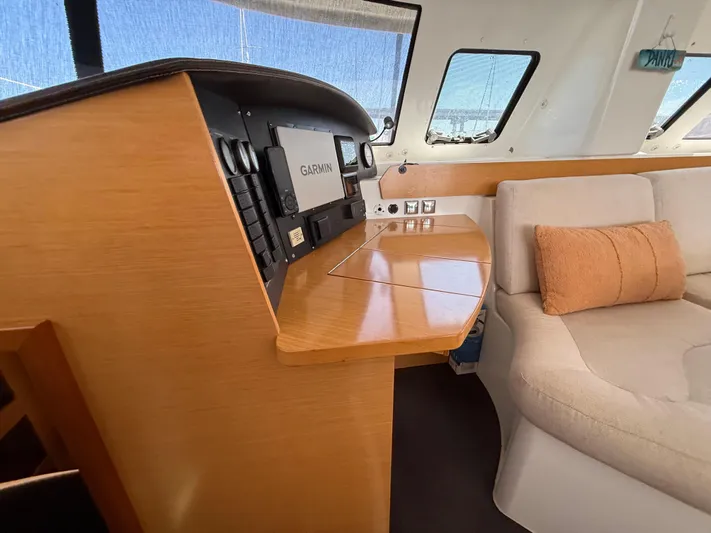 Benevah Yacht Photos Pics Interior of 2013 Fountaine Pajot Lipari 41 catamaran with navigation station and seating area.