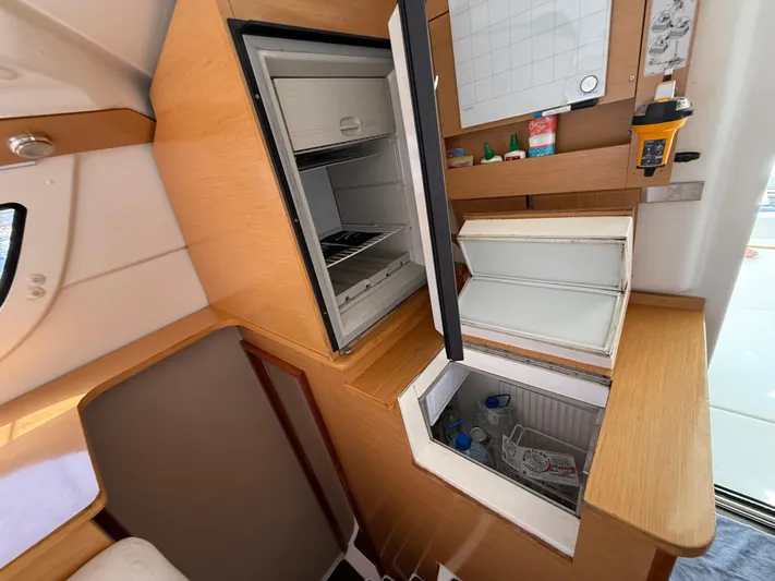 Benevah Yacht Photos Pics Interior of 2013 Fountaine Pajot Lipari 41 catamaran with open fridge and storage.