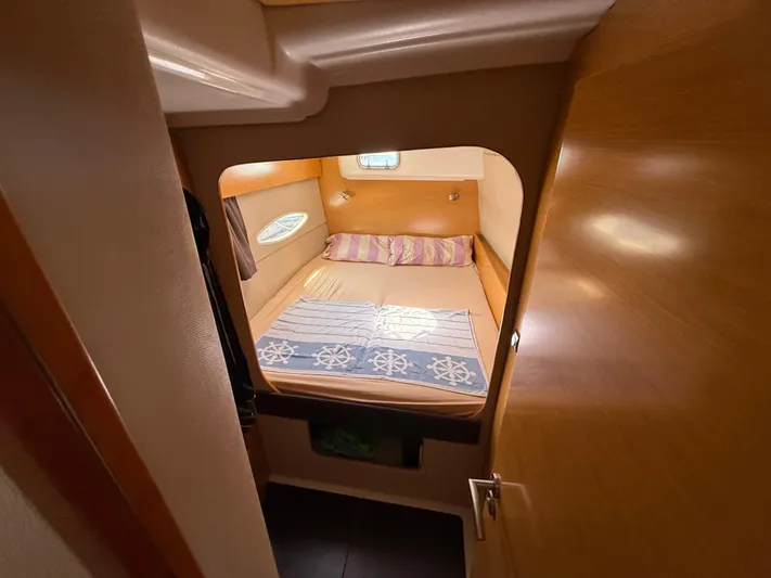 Benevah Yacht Photos Pics Cozy cabin interior of 2013 Fountaine Pajot Lipari 41 catamaran with bed and porthole.