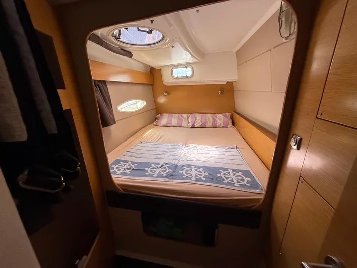 Benevah Yacht Photos Pics Cozy cabin interior of 2013 Fountaine Pajot Lipari 41 catamaran with bed and porthole.