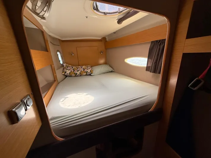 Benevah Yacht Photos Pics Cozy cabin interior of 2013 Fountaine Pajot Lipari 41 catamaran with bed and porthole.